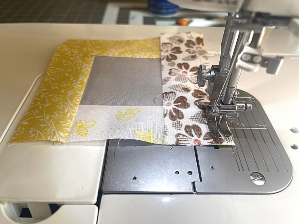 fabric pieces being sewn of sewing machine
