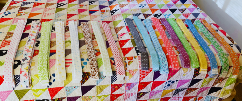 Assortment of fabric cut into 1.5″ strips, simply gorgeous! Light fabrics the the left and dark fabrics to the right.