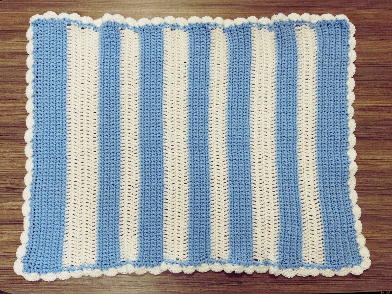 baby blanket crochet pattern finished on table
