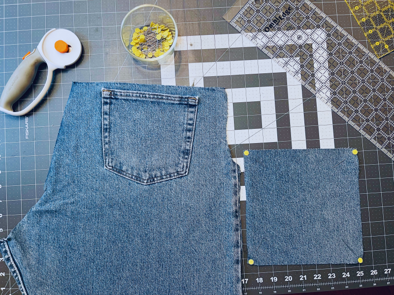 Cutting up jeans to make recycled denim potholders