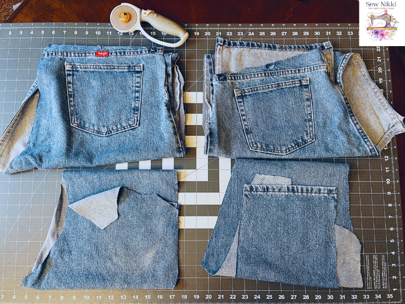Recycled denim jeans for potholders cut into four sections laying on sewing table