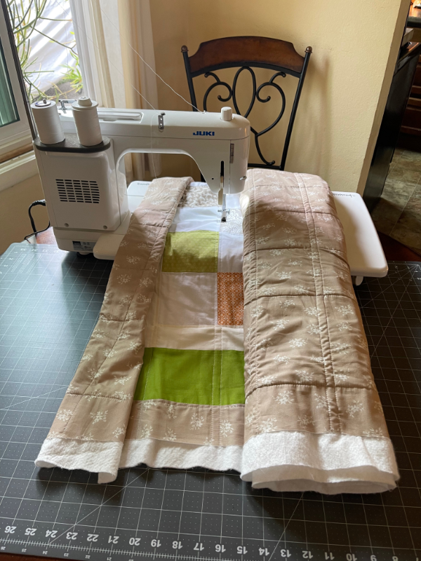 rolled quilt on sewing machine to quilt