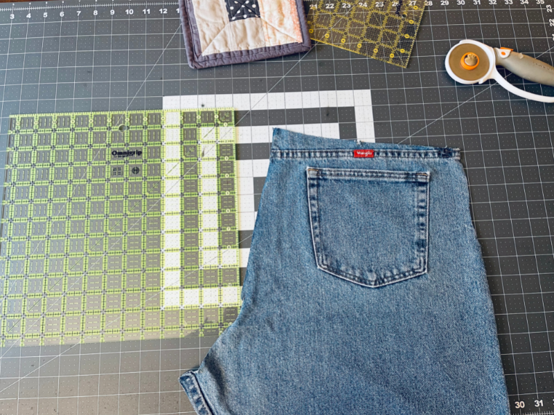 Cutting up  jeans with square ruler and rotary cutter on cutting matt