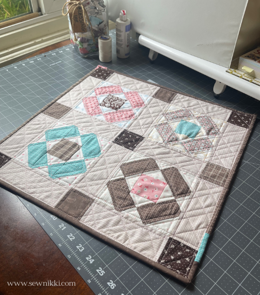 Finished nonsense quilt block table mat on cutting mat