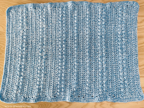 Easy Crochet Baby Blanket finished laying on table