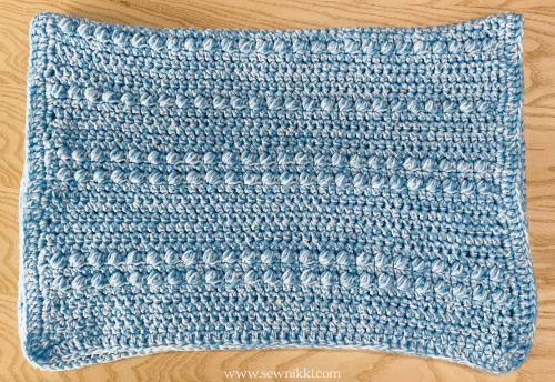 chunky baby blanket crochet pattern, finish blanket folded in half on table