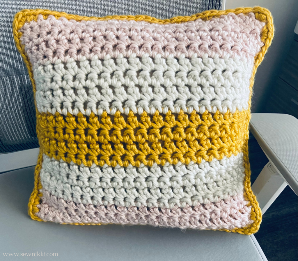 crochet pillow cover pattern free - finished modern crochet pillow on chair