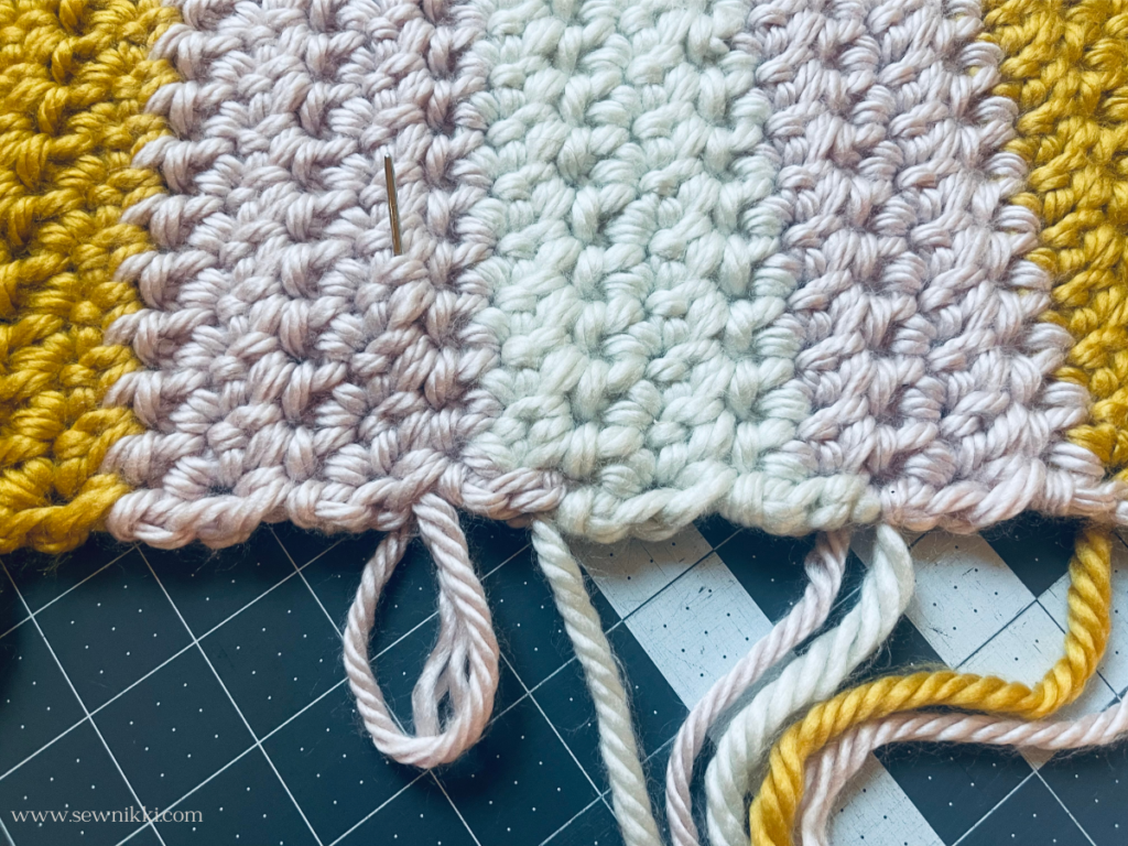 weaving tails into crochet project
