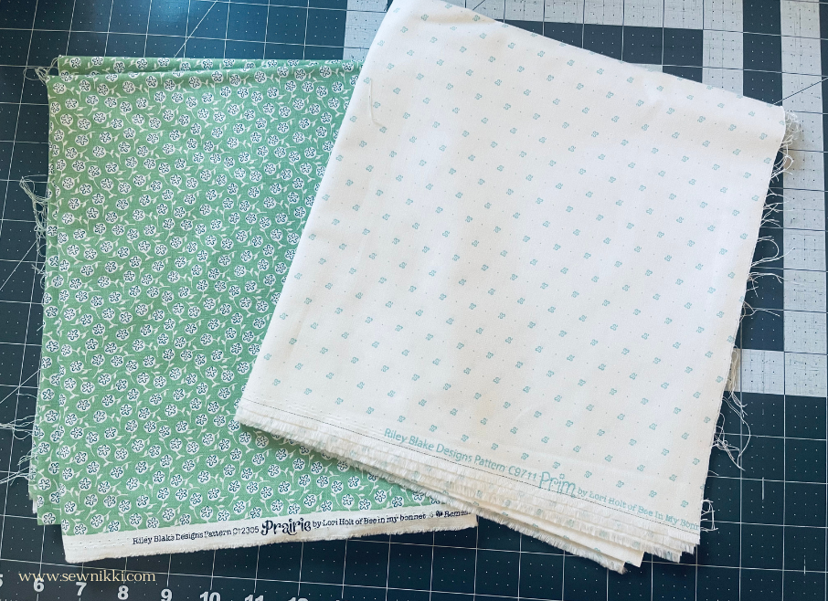 Lori holt fabric laying on cutting mat for free chevron quilt pattern by sew nikki