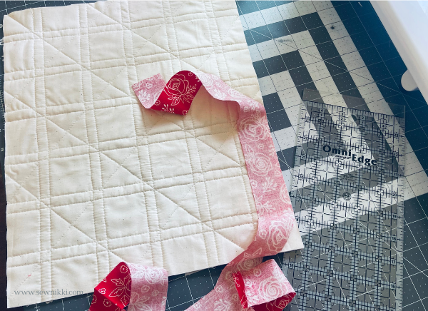 how to bind a quilt tutorial - attaching binding strip to back of quilt top