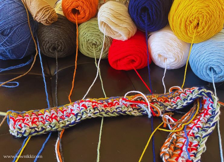 variety of acrylic yarns to form a crochet rug