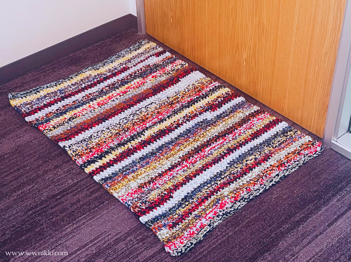 crochet rug laying on floor in front of door