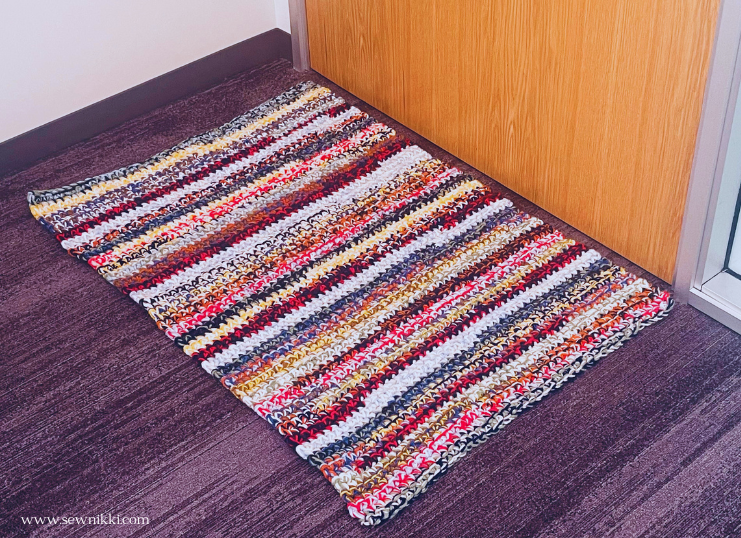 crochet rug laying on floor in front of door