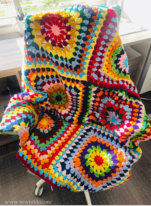 Sunburst granny square blanket by Sew Nikki draped over office chair