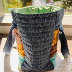 Finished recycled denim handbag side view with quilted stitching