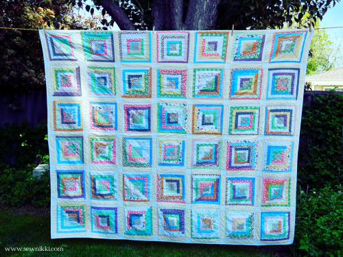 Log cabin quilt with sashing and cornerstones by Sew Nikki