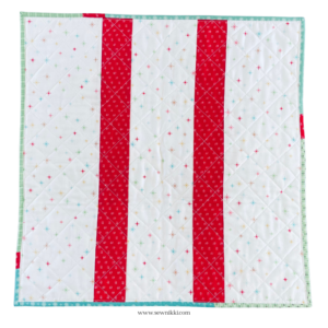 Printable Pinwheel Quilt Pattern (Table Topper) – finished back of quilt by Sew Nikki.