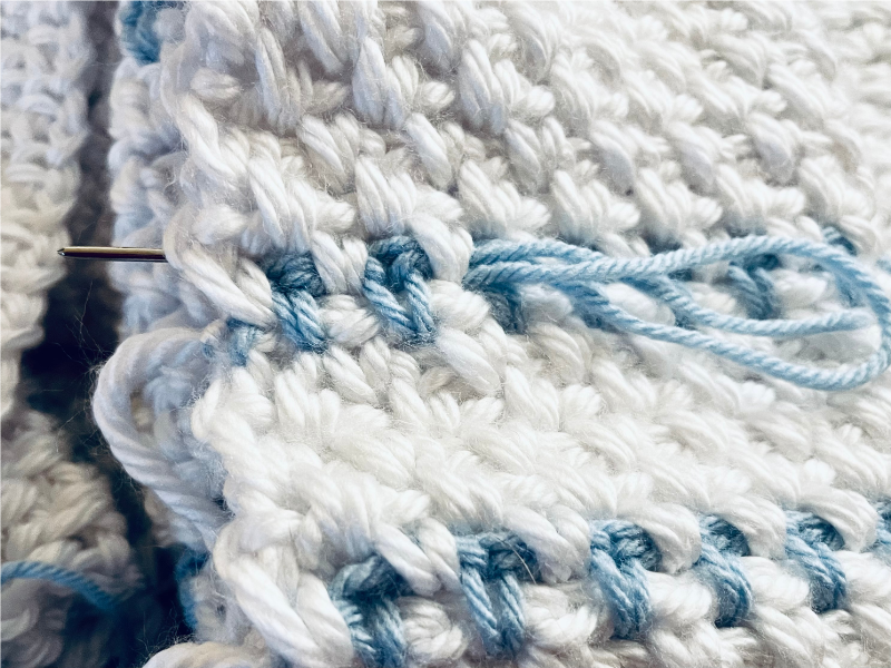 Quick and Easy Baby Blanket Crochet - weaving tails with yarn needle by Sew Nikki