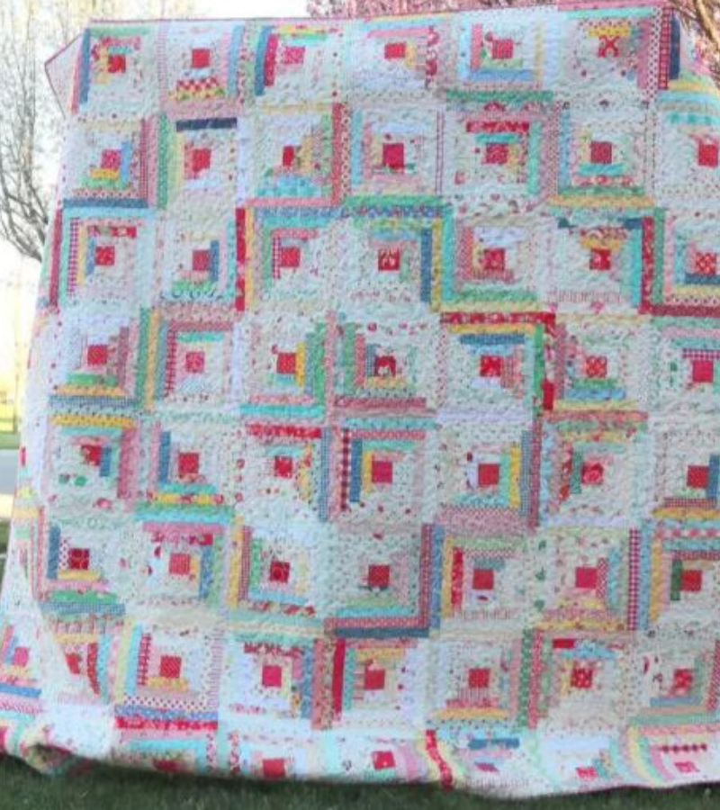 Vintage inspired log cabin quilt with diagonal design from blocks running through the quilt by Amy Smart, Diary of a Quilter.