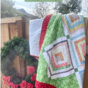 Free Log Cabin Quilt Pattern On-Point by Sew Nikki - completed folded full size quilt hanging over fence with wreath. (Pinterest)