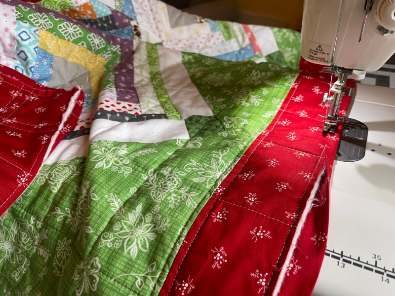 How to sew binding on a quilt by Sew Nikki - Attaching binding to the last side of quilt.