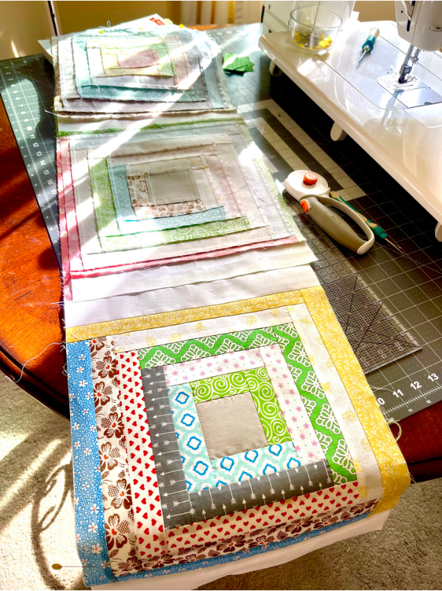 Log Cabin Quilt Patterns - Sashing strips have been added to one quilt row by Sew Nikki.