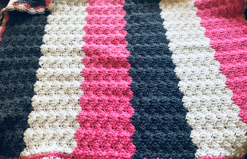 Crochet shell stitch striped baby blanket by Sew Nikki.
