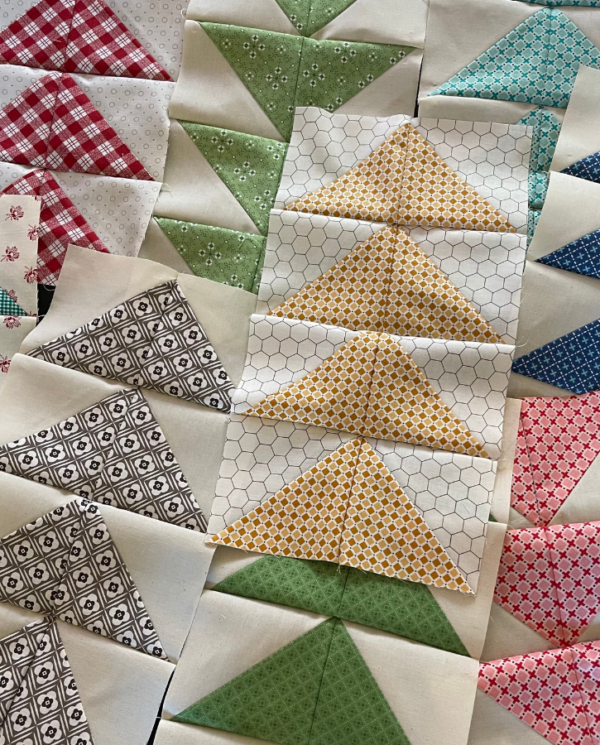 Flying geese quilt pattern made with half-square triangles by Sew Nikki.