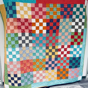 Scrappy Quilt Patterns - Front view of finished Checkerboard Quilt by Sew Nikki