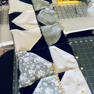 Big Stars Quilt by Sew Nikki – carefully pinning the quilt top sections together on extension table. Big Stars Quilt by Sew Nikki - carefully pinning the quilt top sections together on extension table.