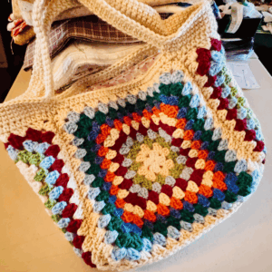 Granny handbag crochet bag pattern by Sew Nikki - finished bag on my sewing table.