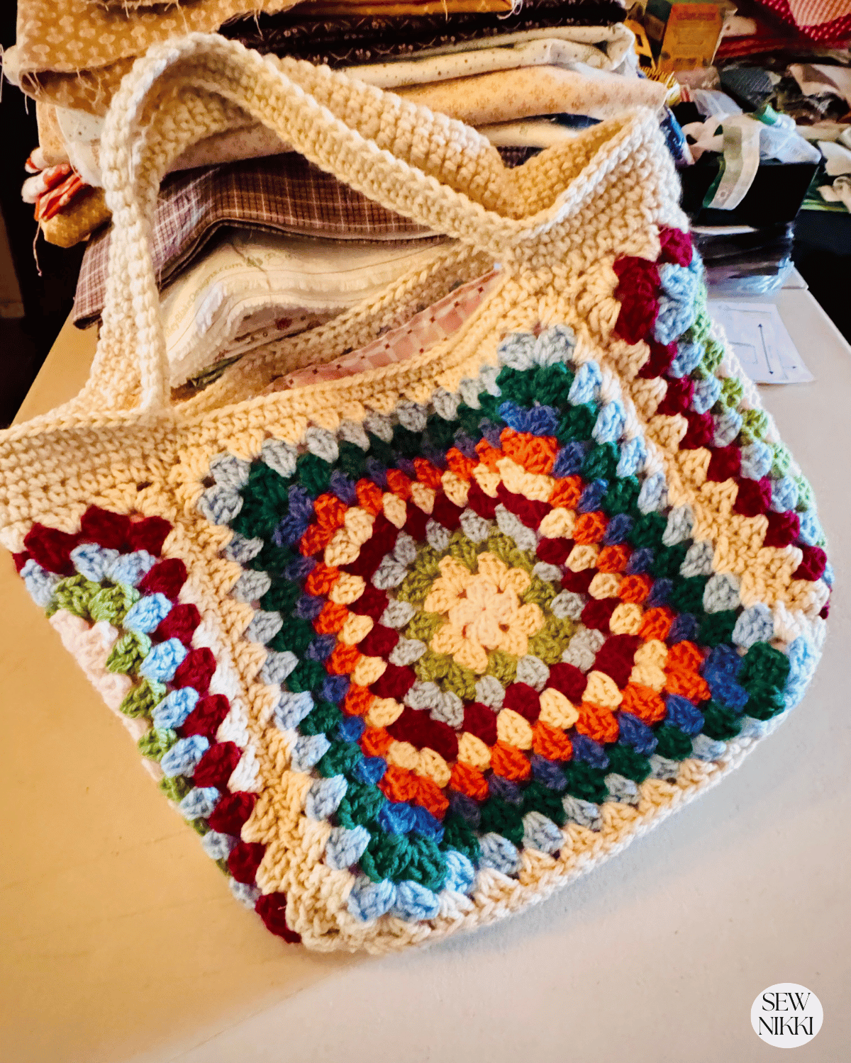 Granny handbag crochet bag pattern by Sew Nikki - finished bag on my sewing table.