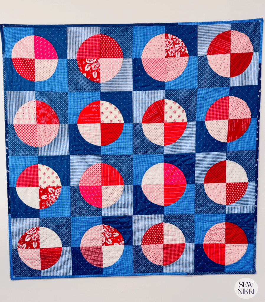Finished Circle Baby Quilt hanging on my office wall by Sew Nikki