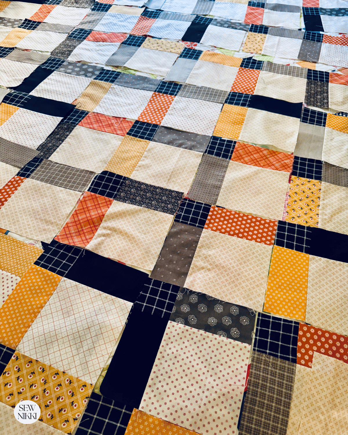 On Point Disappearing Nine Patch Quilt Pattern by Sew Nikki - laying the blocks out before sewing together.