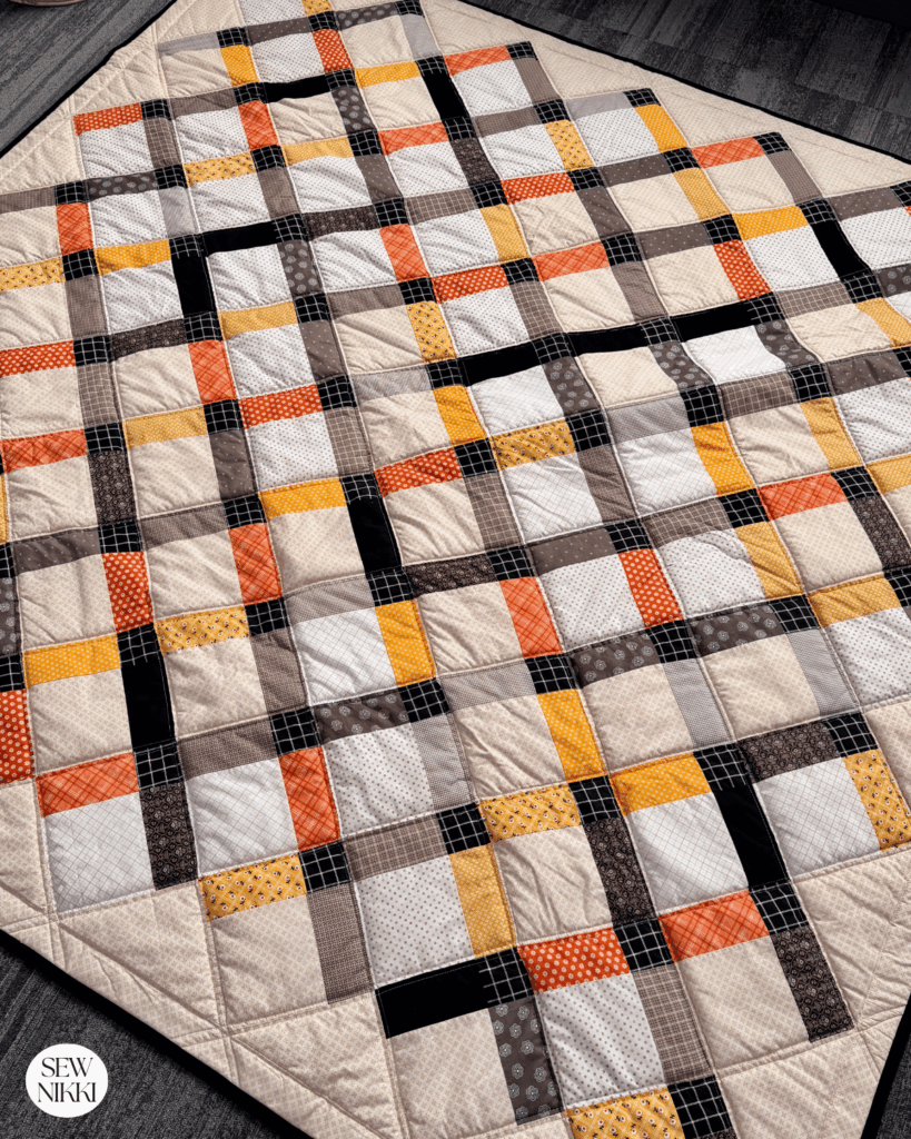 Finished Disappearing 9 Patch queen size quilt by Sew Nikki made on a home sewing machine.
