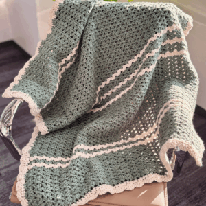 Iris Stitch Baby Blanket Crochet Pattern Free by Sew Nikki - finished blanket over chair.