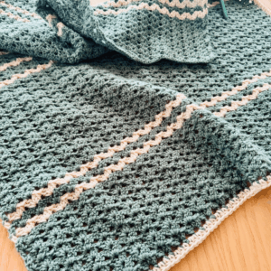 Working the first border round for this baby blanket crochet pattern free by Sew Nikki