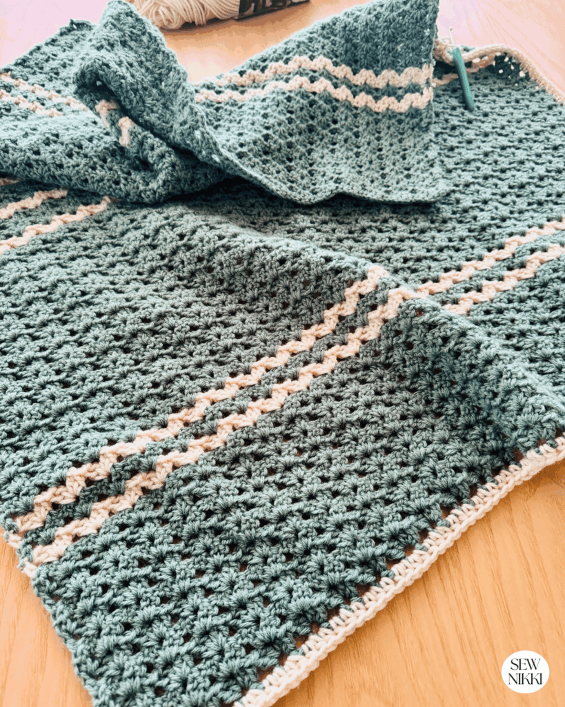 Working the first border round for this baby blanket crochet pattern free by Sew Nikki