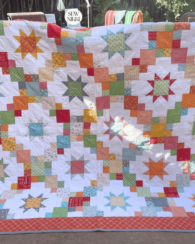 Finished Cluck Cluck Sew Brightly quilt by Sew Nikki - air drying over patio chairs outside.