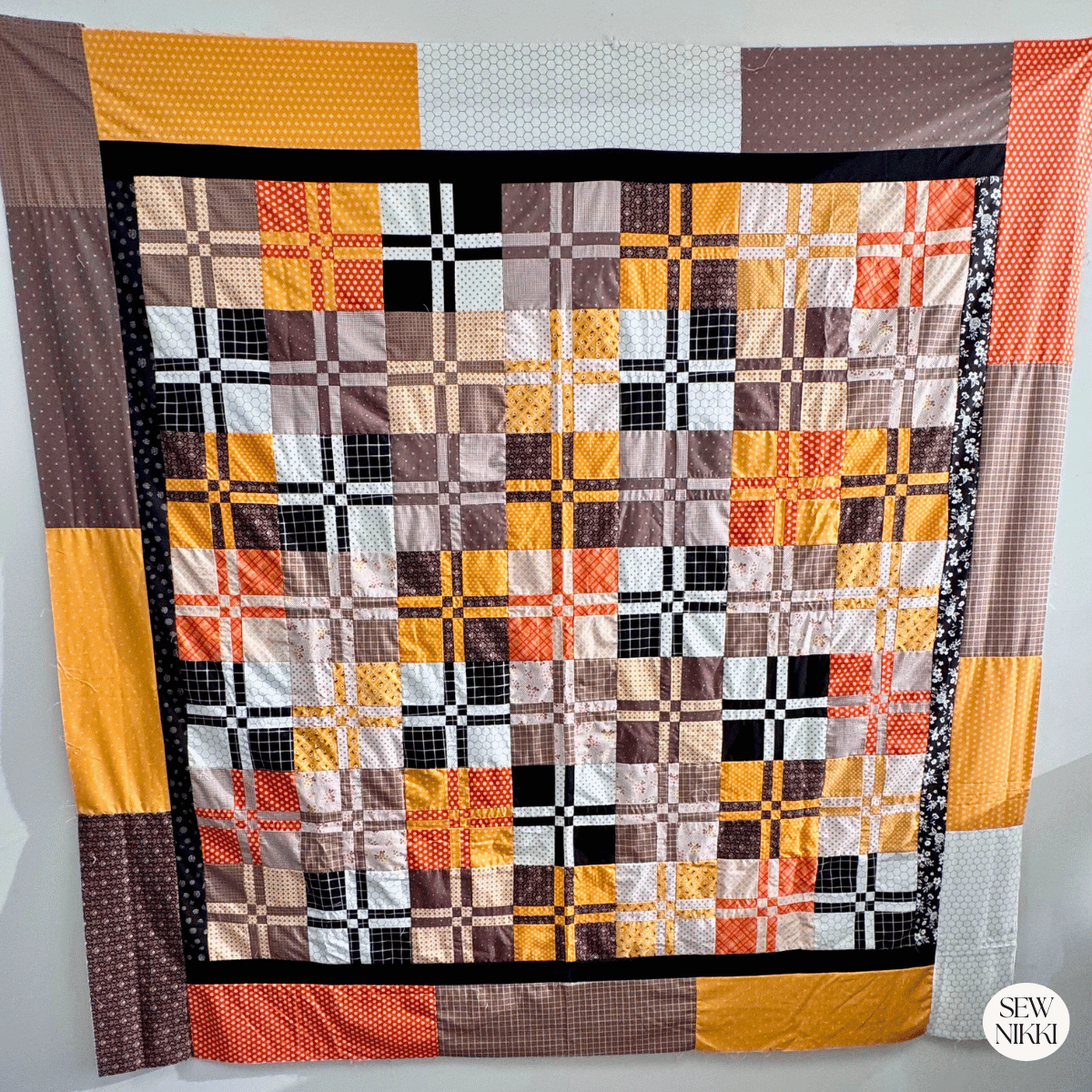 Finished Bella Disappearing four patch quilt pattern by Sew Nikki