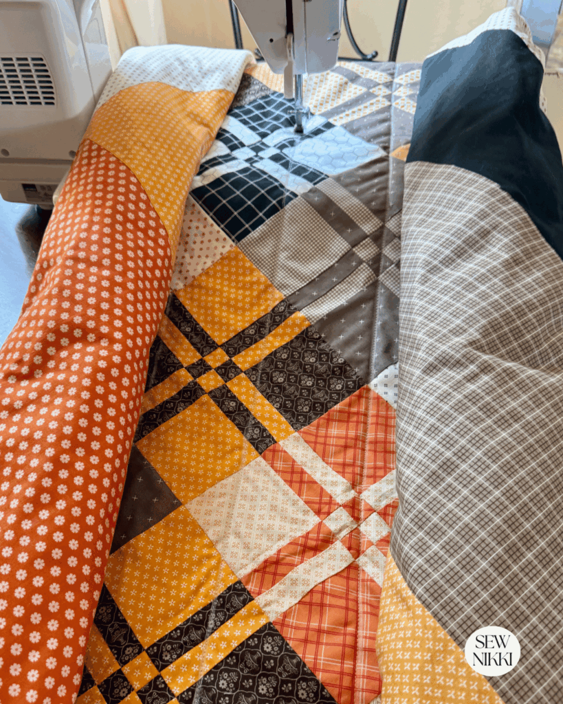 Roll up both sides of your quilt on the diagonal and straight stitch following the chalk lines by Sew Nikki