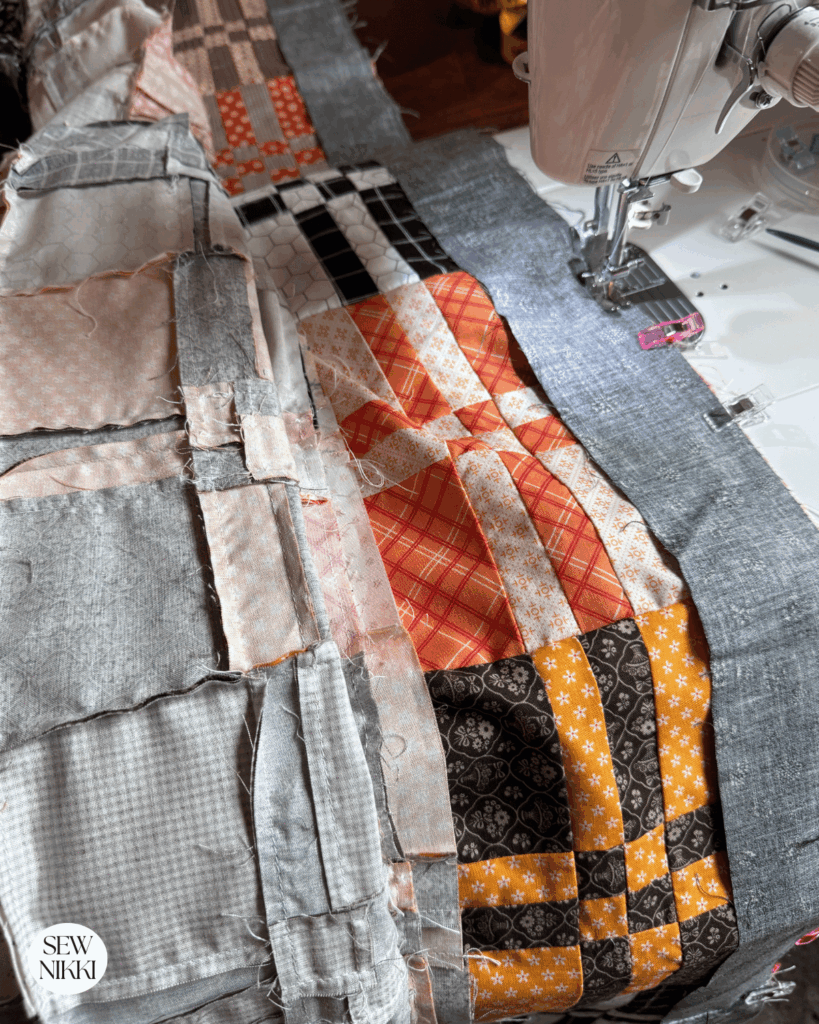 Sewing borders onto the free disappearing four patch quilt pattern by Sew Nikki