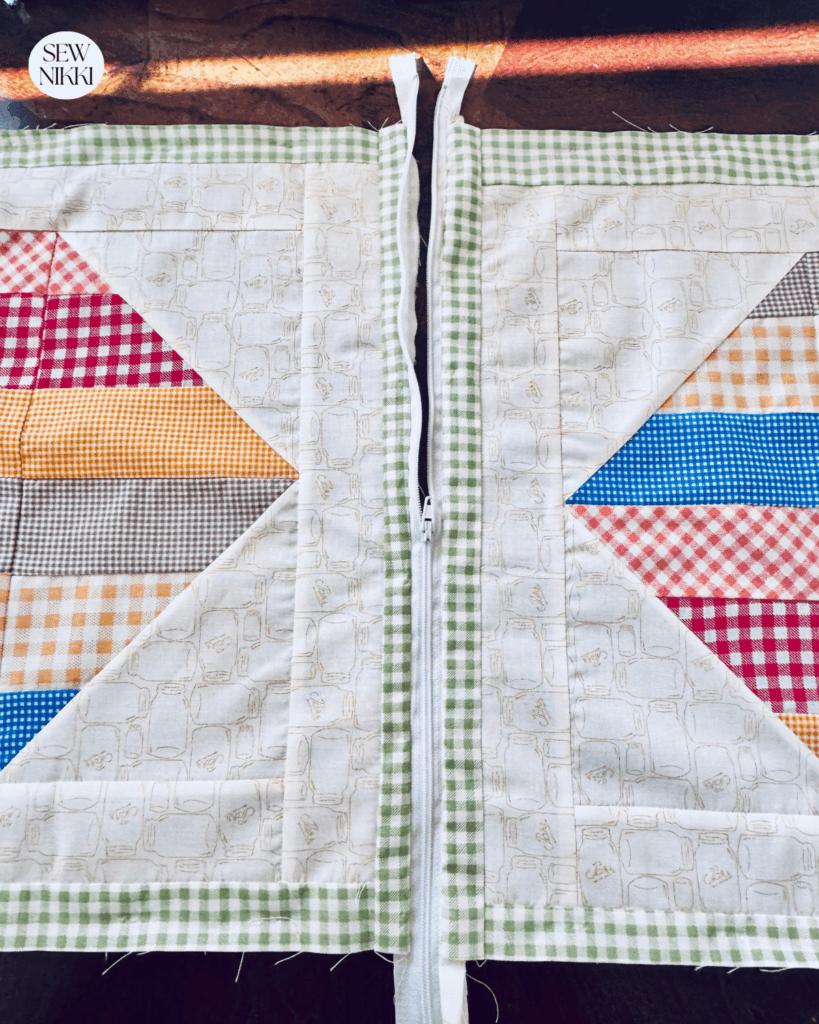 Slide zipper pull into the middle of your work before sewing the sides closed by Sew Nikki