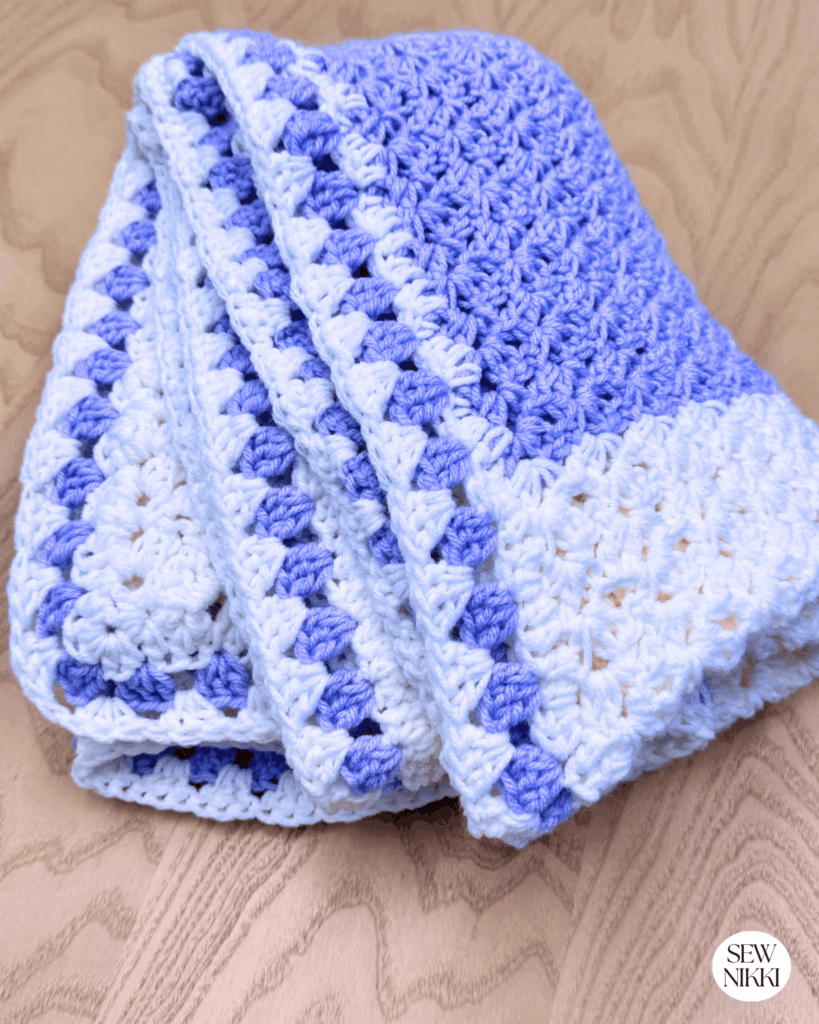 Free crochet pattern by Sew Nikki folded up with beautiful granny stitch border.