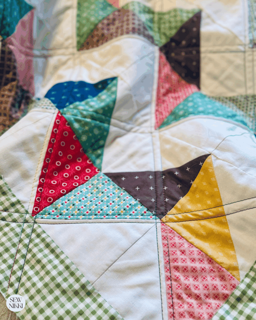 Multi colored quilting thread looks great on scrappy quilts by Sew Nikki