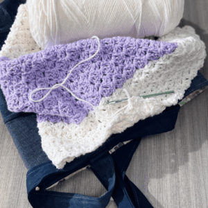Reverse blanket stitch blanket in progress sitting on denim tote bag by Sew Nikki