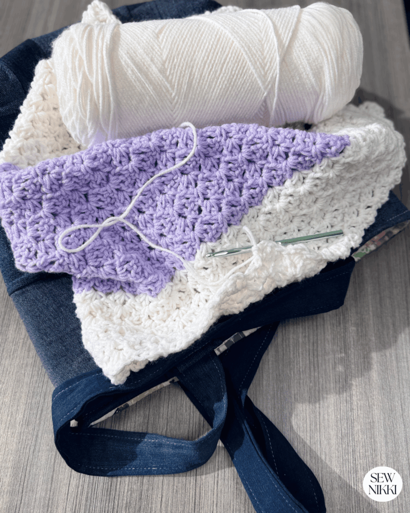 Reverse blanket stitch blanket in progress sitting on denim tote bag by Sew Nikki
