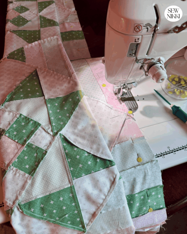 Sewing the rows together for the Stars and Stripes quilt pattern by Sew Nikki using the Ohio Star quilt block.
