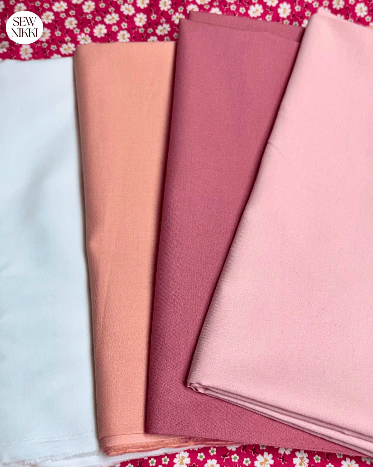 Solid and print quilt fabric laying on cutting mat