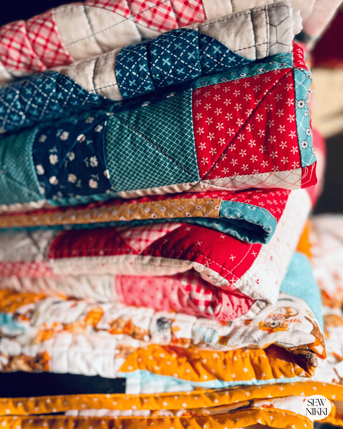 How to make a quilt look more modern - stack of quilts made by Sew Nikki